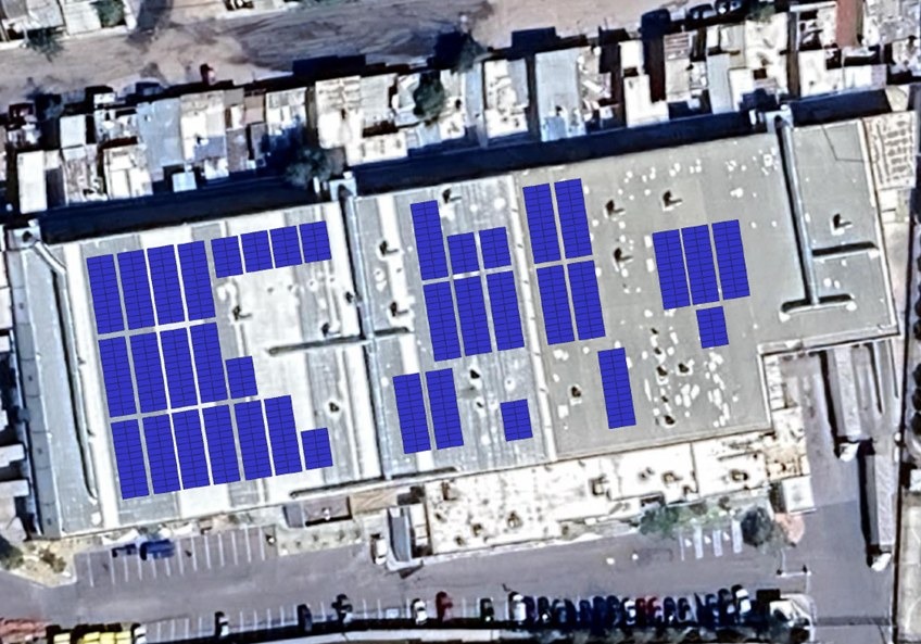 Vista aérea del diseño de siembra de paneles solares sobre el techo de una nave industrial